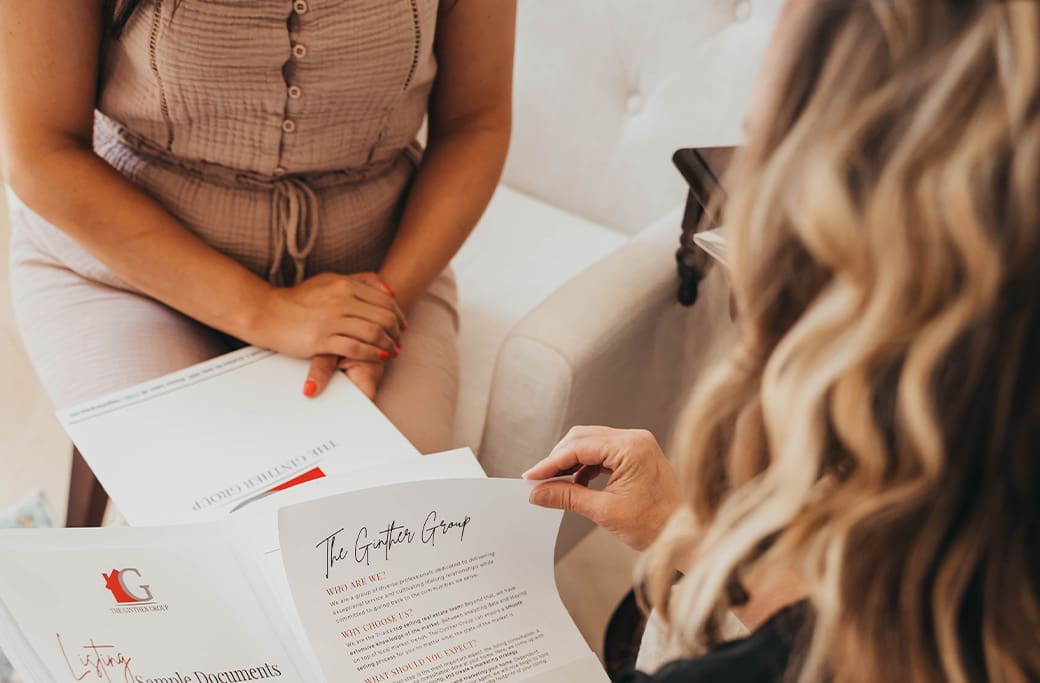 Real estate agent and homeowner walking through the listing process before preparing it for sale