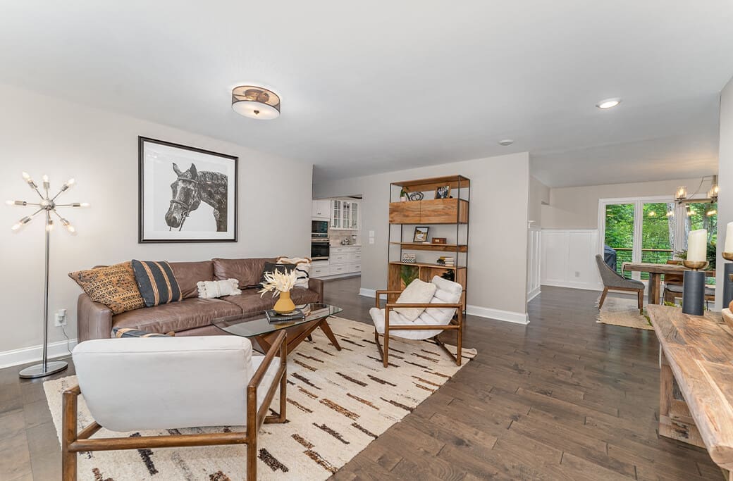 Living room with leather sofa, modern furniture, and artwork, suitable for Winston-Salem home sale.