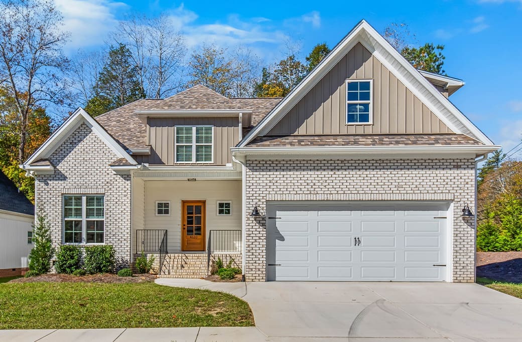 Modern family home in a Winston-Salem neighborhood, featuring a brick exterior and garage.