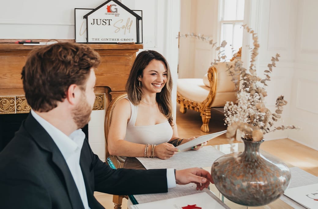 The Ginther Group "Just Sold" sign with happy real estate agents