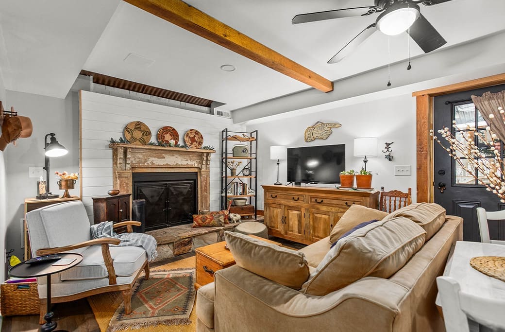 Cozy living room with fireplace, TV, and sofa, ready for sale in Winston-Salem