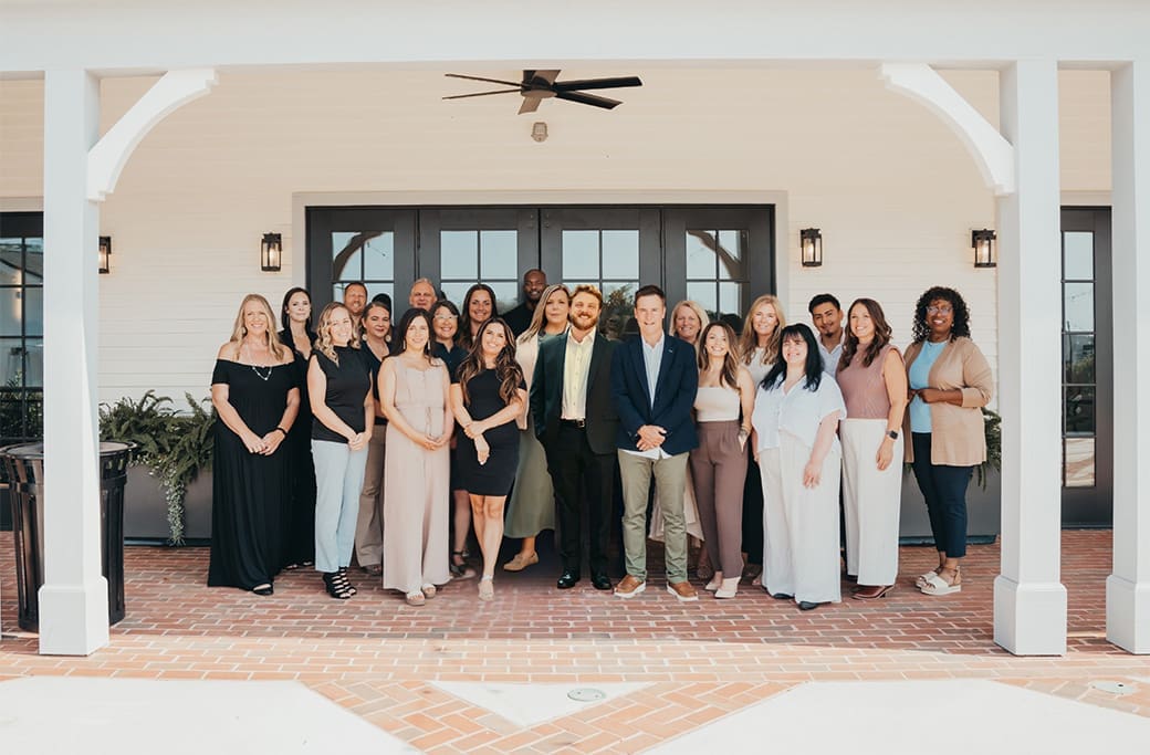 Winston-Salem real estate agents posing for a team photo outdoors.