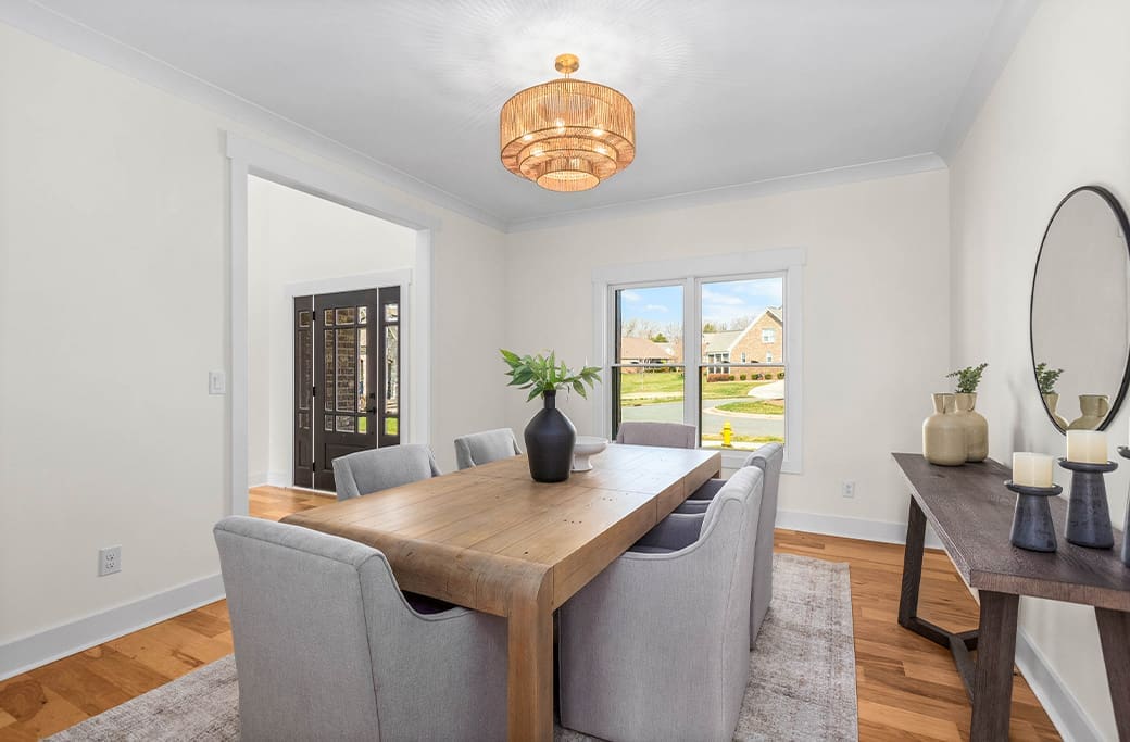 Modern dining room with light gray chairs and a wood table, perfect for a Winston-Salem home.